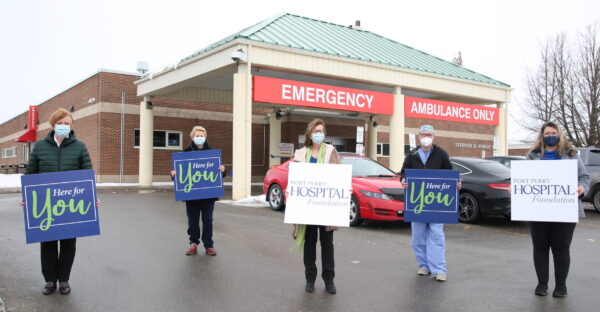 Group holding Here for your Placards, CT scanner Port Perry