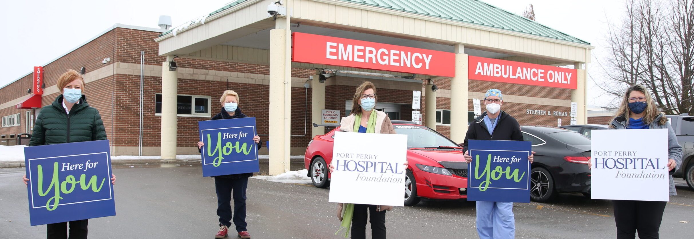 Group holding Here for your Placards, CT scanner Port Perry