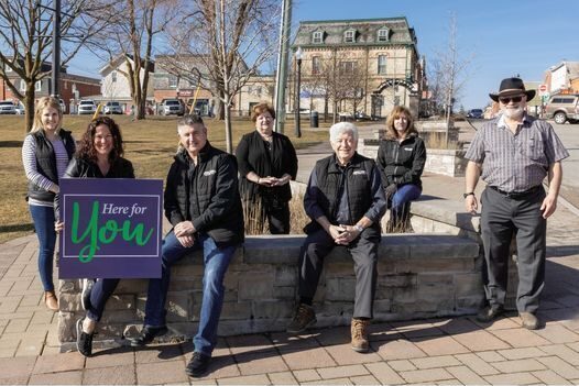 Puckrin and Latreille Real Estate Team holding a Here for You campaign poster