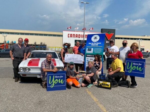 Roar by the Shore cheque presentation outside of Canadian Tire Port Perry with a classic car