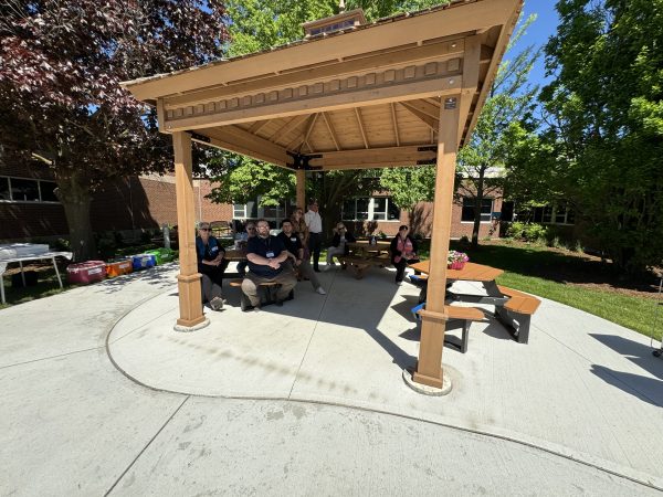 Attendees under the pergola in the healing garden