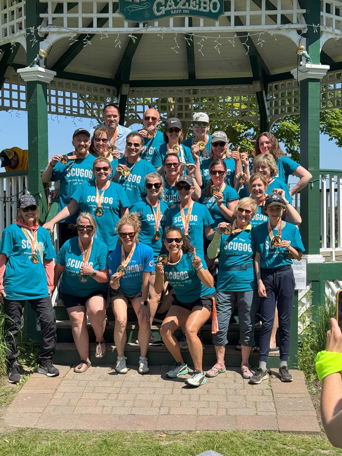 Scugog Dragon Boat Club team group photo by the gazebo.