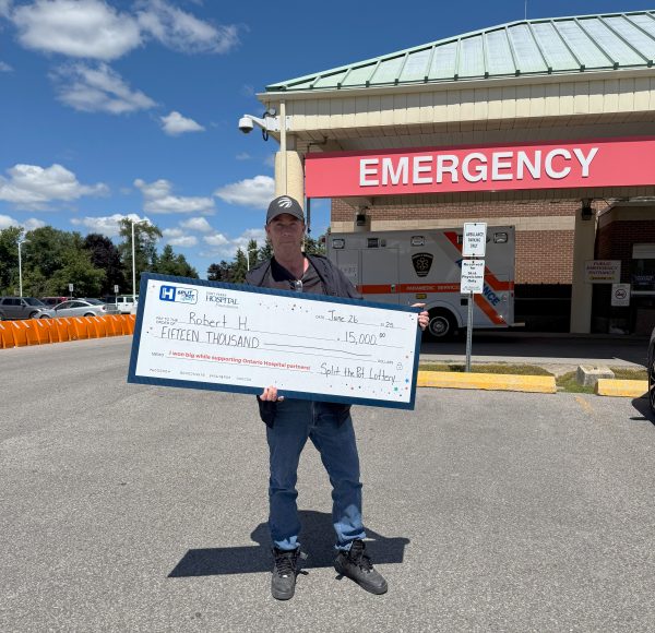 Robert holding cheque presentation sign.