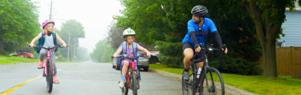 2 young girls riding with their father